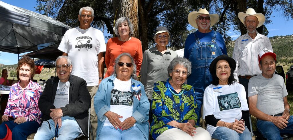 This year's attendees who were born in Dawson gather for a group photo. Dolores Huerta, the celebrated American labor leader, is seated second from right. (Photo courtesy of John Denne)